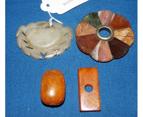 A carved jade crab, 4.5 cm wide, a hardstone sample roundel, an amber bead and another similar (4) Condition report Report by