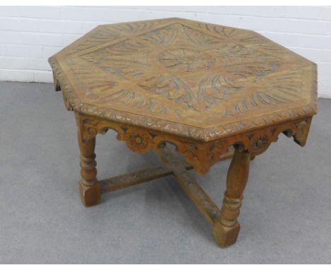 Oak table the octagonal top with carved floral pattern, on ring turned legs with cross stretcher, 52 x 85cm , 