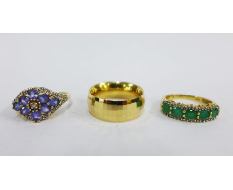 Three 14ct gold rings to include a five stone emerald and diamond ring, a tanzanite ring and a wedding band (3) 