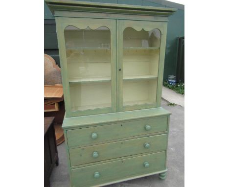 Late C19th pine kitchen cabinet with two glazed doors above three drawers with turn wooden handles and feet, distressed green