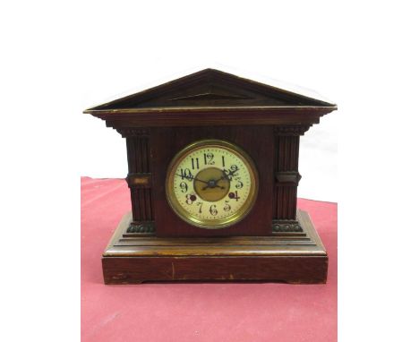 Early 20th C mantle clock in medium oak architectural case, brass bezel enclosing ceramic dial, twin train movement striking 