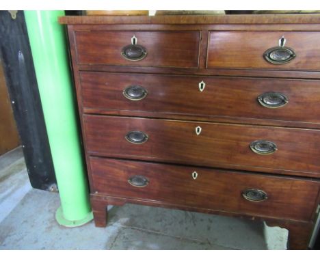 Early C19th mahogany chest of two short and three long graduated cock beaded drawers with brass handles on shaped bracket fee