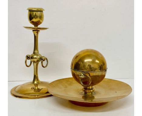A brass effect inkwell and candlestick 
