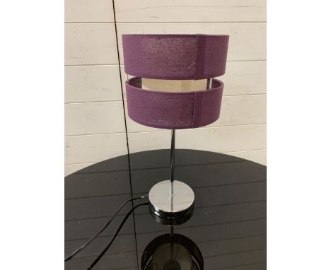 A chrome bedside lamp with purple shade 