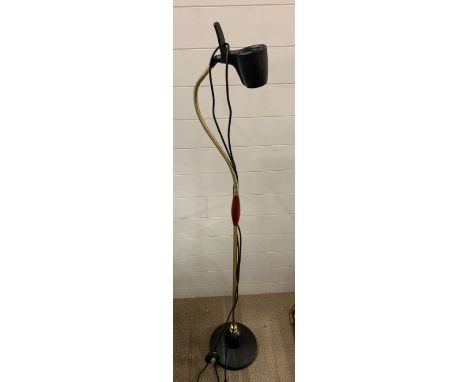A floor standing brass spot light 