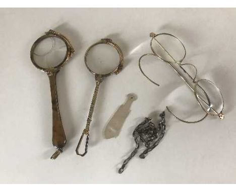 Two lorgnettes, spectacles, silver chain and a mother of pearl fish