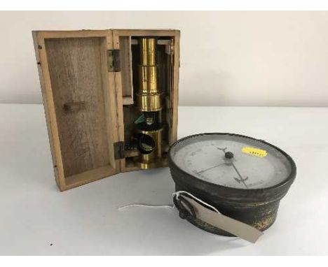 A brass cased circular barometer and miniature brass telescope in fitted wooden box 
