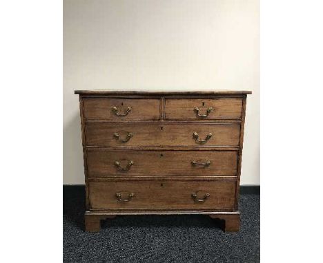 A Victorian inlaid mahogany five drawer chest on bracket feet 