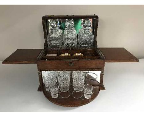 A Victorian oak three decanter tantalus and bridge box 