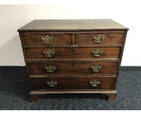 An early 19th century mahogany five drawer chest on bracket feet 