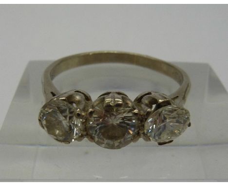A three stone diamond ring set in white metal, approximately 1.75ct total diamond weight, one stone loose, size R