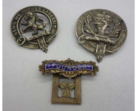 A Scottish silver Audaces Juvo badge, a silver and enamel Founder badge and one other badge