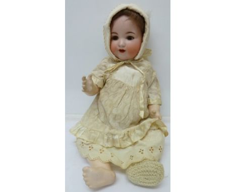 An Armand Marseille, 990, A10M bisque-head doll, with brown sleeping eyes and eye lashes, height 50cm