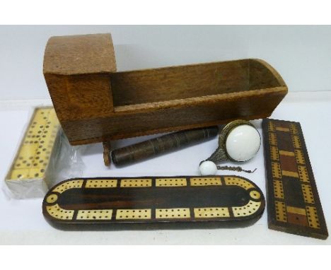 An oak dolls cradle, two cribbage boards, a bell mechanism, dominoes and a needle case