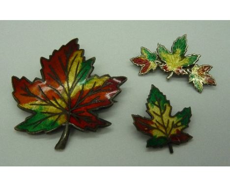 Three silver and enamel maple leaf brooches