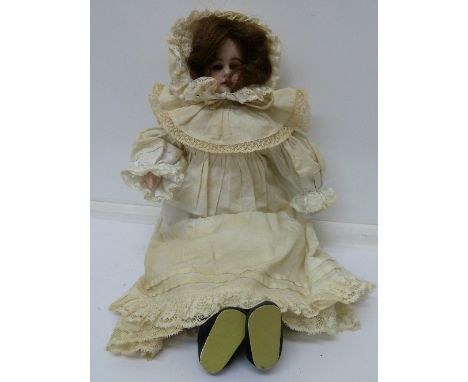 A 19th Century bisque doll, with blue sleeping eyes, the back marked 3093, height 34cm