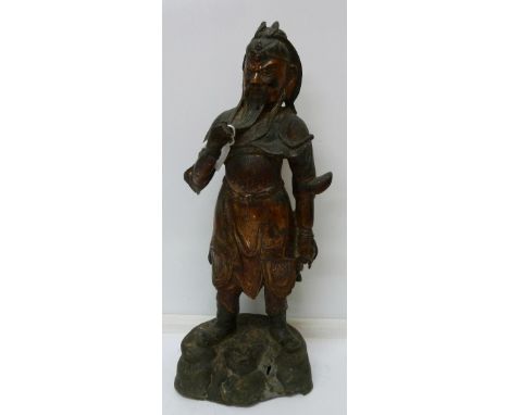 A Chinese patinated bronze figure of a warrior, height 35cm