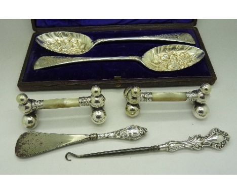 A cased set of silver plated berry spoons, a pair of plated knife rests with mother of pearl supports and two silver handled 
