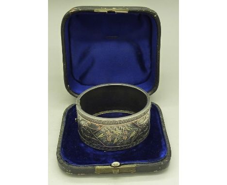 A wide Victorian white metal and gold overlay bangle, cased, 31mm