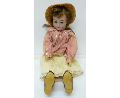 A bisque head child doll, with blue sleeping eyes, jointed body, impressed Gbr in a Sunburst for Gebruder Khoch 133-25, heigh