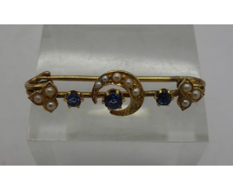 A yellow metal, sapphire and pearl brooch, weight 2.1g, lacking two pearls