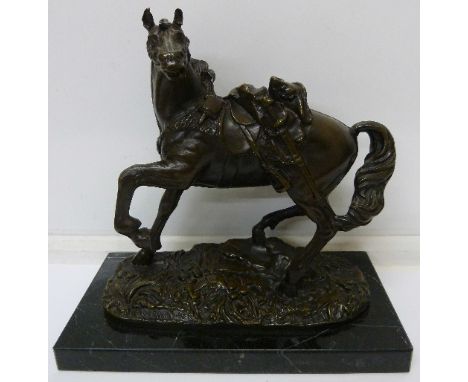 A late 19th Century French bronze figure of a war horse, indistinctly signed to the base, mounted on black marble plinth, hei