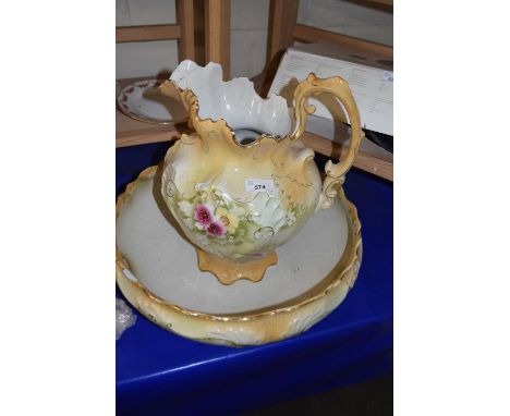 A floral decorated wash basin and jug