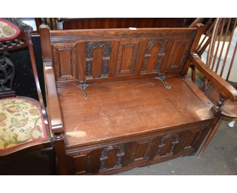 A stained oak monks bench