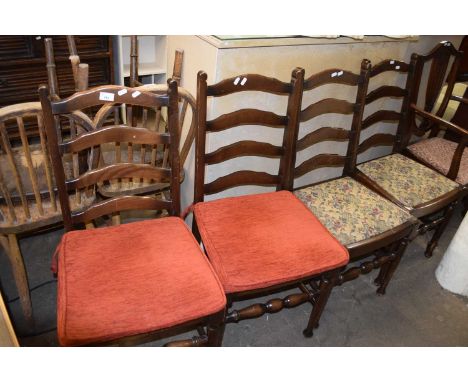 A set of four ladder back dining chairs