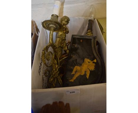 A two branch gilt metal cherub wall light with a key plaque and brushes