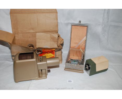 A Kodak Kodaslide Home Projector together with a Cabin Compact Slide Projector (boxed).