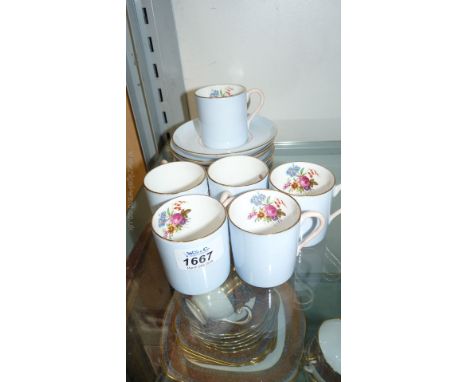 Six Copeland coffee cans and saucers with floral design inside and plain pale blue outside