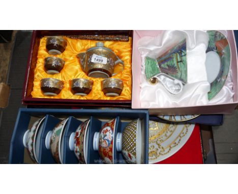 A quantity of boxed items including oriental display plate, Saki cups and saucers, etc.