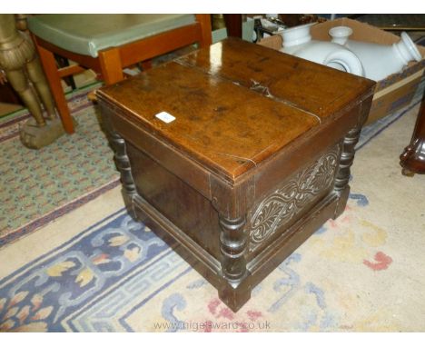 A 17th c. style Oak Commode Stool having two plank solid lid, on panelled stool frame base, peg joined and with ceramic chamb