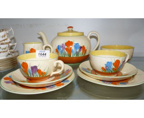 A Clarice Cliff 'Crocus' pattern Tea Service for two including Teapot, two cups, saucers and side plates, sugar bowl and milk