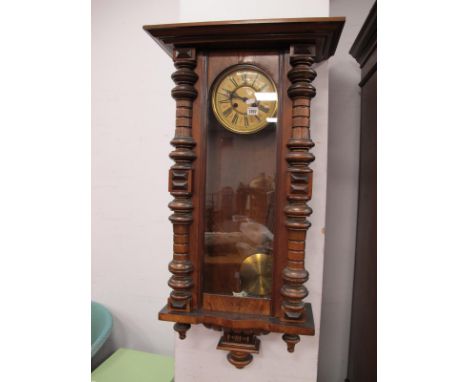 A XIX Century Walnut Vienna Wall Clock, with a circular dial, Roman numerals, gadrooned base, turned finials.