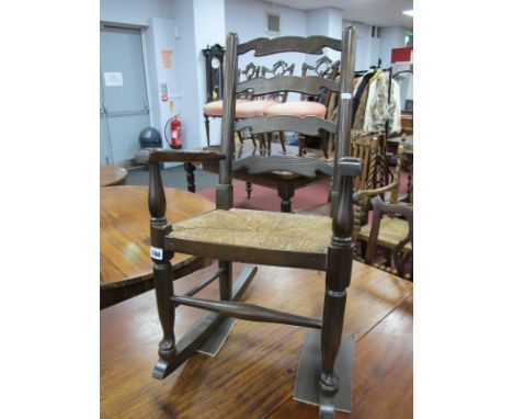 A XIX Century Style Child's Elm-Ash Ladder Back Rocking Chair, with a rush seat.