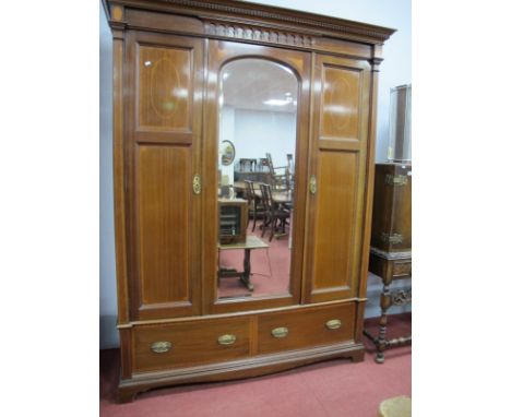 And Edwardian Inlaid Mahogany Triple Wardrobe,with dentil cornice to arch decorated pediment, central mirror door flanked by 