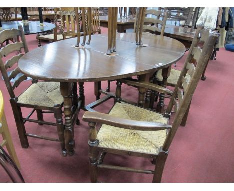 An Oak Leaf  Table, on turned and block supports; together with a set of four (two arms and two single) ladder back chairs, w