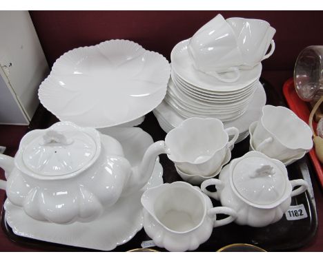 A Shelley Bone China Tea Set, in plain white with scalloped border detail, comprising teapot, milk jug, sugar basin, comport,