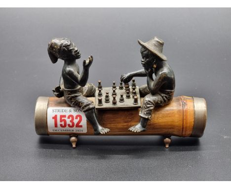 An unusual cold painted bronze and bamboo figure group of two Natives playing a board game,&nbsp;13.5cm long.