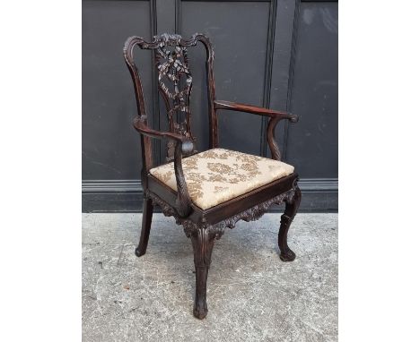 An antique Chippendale style carved mahogany elbow chair. 
