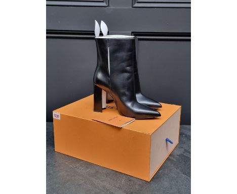 Louis Vuitton:&nbsp;a pair of black and white leather ankle boots, EU 39, in box (splits to lid). All proceeds to the Aldingb
