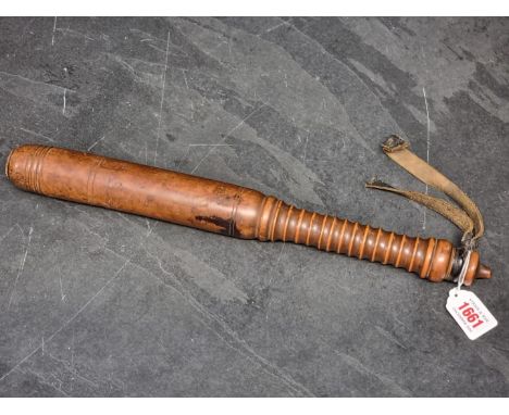 A Victorian turned wood truncheon, 42cm, with remains of leather strap.
