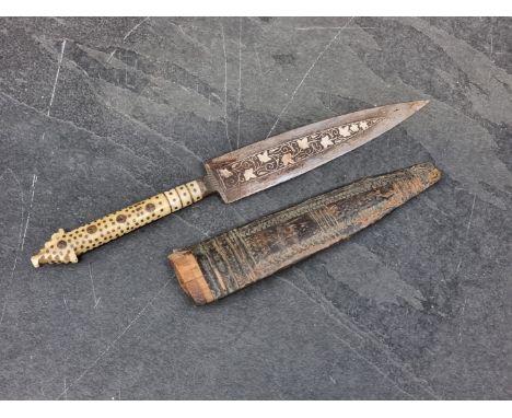 A dagger and leather sheath, the 11.5cm blade with gilt decoration, with bone grip.