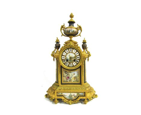 A 19th Century French gilt metal mantel clock, various waterside and village scene panels, with central panel depicting boy a