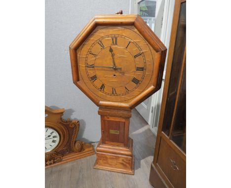 A mid 19th Century pine tavern clock with large octagonal dial, the brown Roman numeral dial attached on a floor standing lon