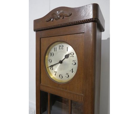 An oak longcase clock, with silvered Arabic dial, front door with three bevel edged glazed panels, with weights and pendulum,