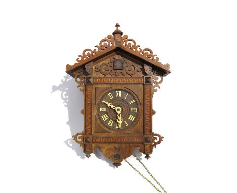A 19th Century German walnut and parquetry inlaid cuckoo clock with bone hands and Roman numerals, with pendulum and weights