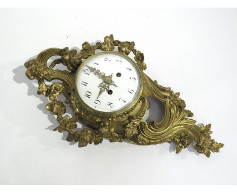 A gilt metal Rococo style cartel wall clock, with floral design, white Arabic numeral dial with outer minutes track and ornat